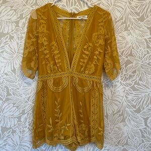 Yellow floral romper. Mesh material.